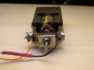 The motor has one tab for the brush connections soldered to the motor frame, which completes the electrical circuit with the locomotive frame.