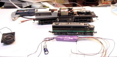 Sound decoder, N Scale locomotive, and frame of a similar locomotive in HO.